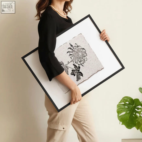 A framed floral print of black ink chrysanthemums on off-white textured paper in a french country botanical style