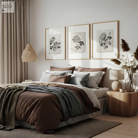 Cozy bed with earthy brown gray and white bedding under french country botanical floral print chrysanthemum wall art set