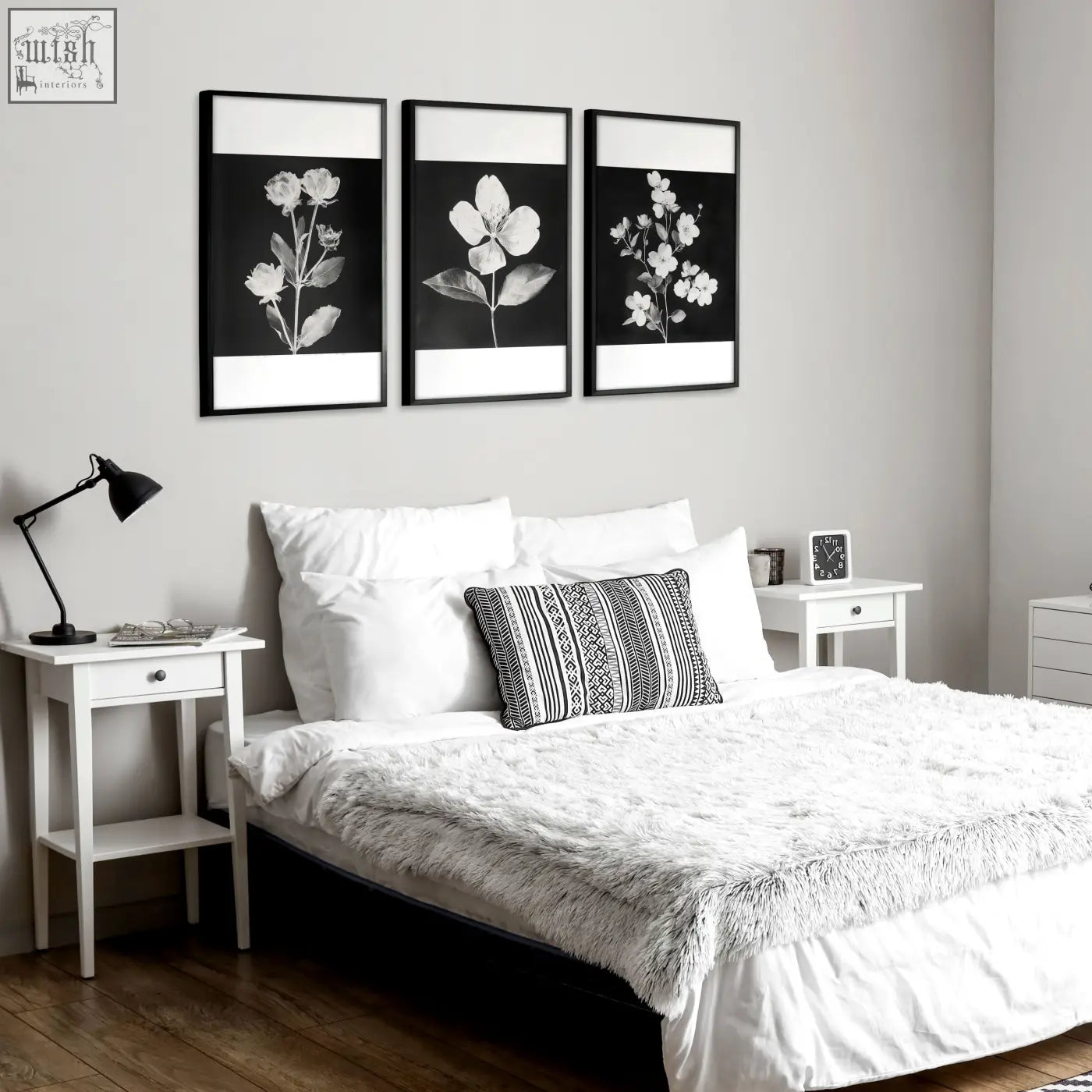 Black and white floral wall art prints in thin black frames hanging above the bed perfect for botanical wall decor