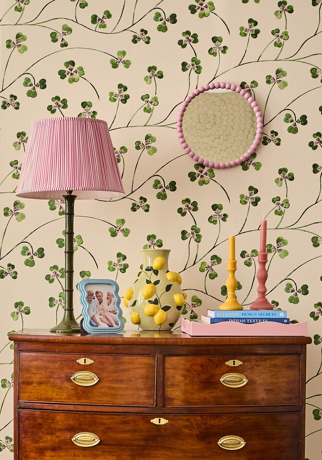 A pale yellow ceramic vase with hand-painted lemons featured with the florence pillar candle rose set of 2
