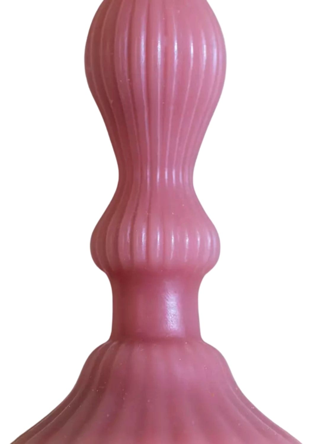 A pink ribbed silicone dildo with flared base and tapered top featured alongside the florence pillar candle rose set of 2