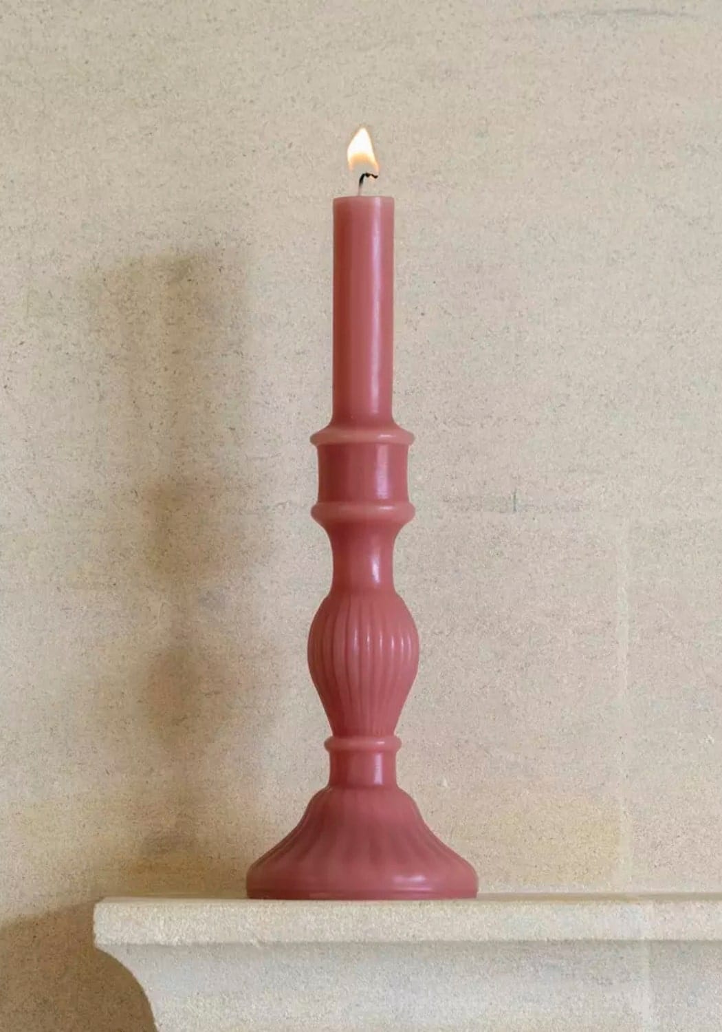 A tall slender rose florence pillar candle 32cm with a lit flame in an ornate matching holder set of 2