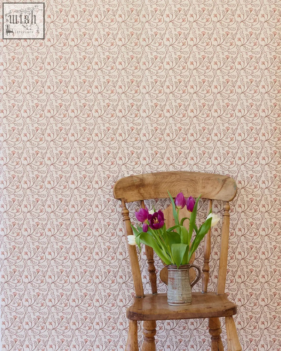 A rustic wooden chair with a vintage metal pitcher of purple and white tulips in front of florence wallpaper shell small repeat