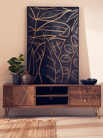 Dark blue canvas painting with gold leaf patterns above a wooden flori media unit for stylish storage
