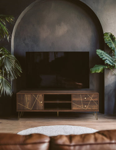 Dark wood flori media unit with geometric gold inlay patterns and slim metal legs perfect for stylish storage