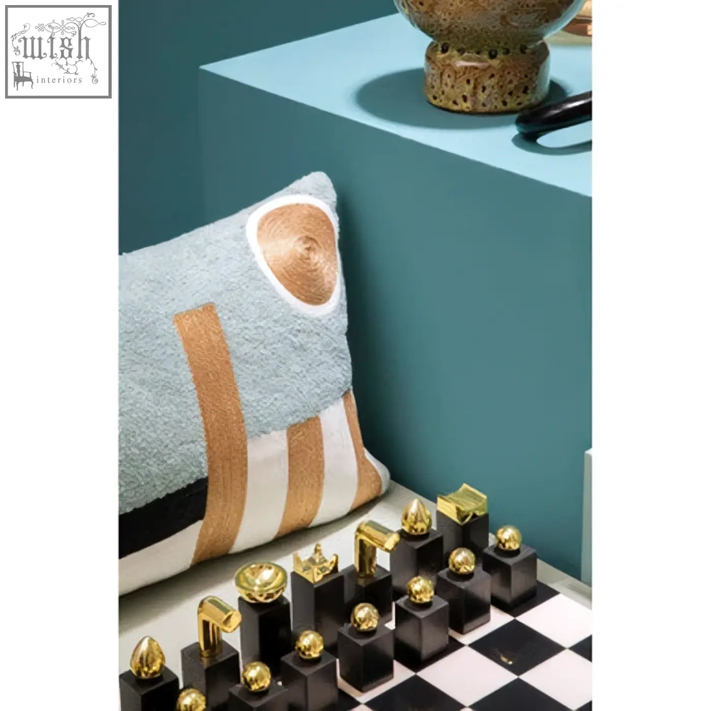 Flos marble and wood chess set with glossy black and gold metallic pieces on a checkered wood chess board