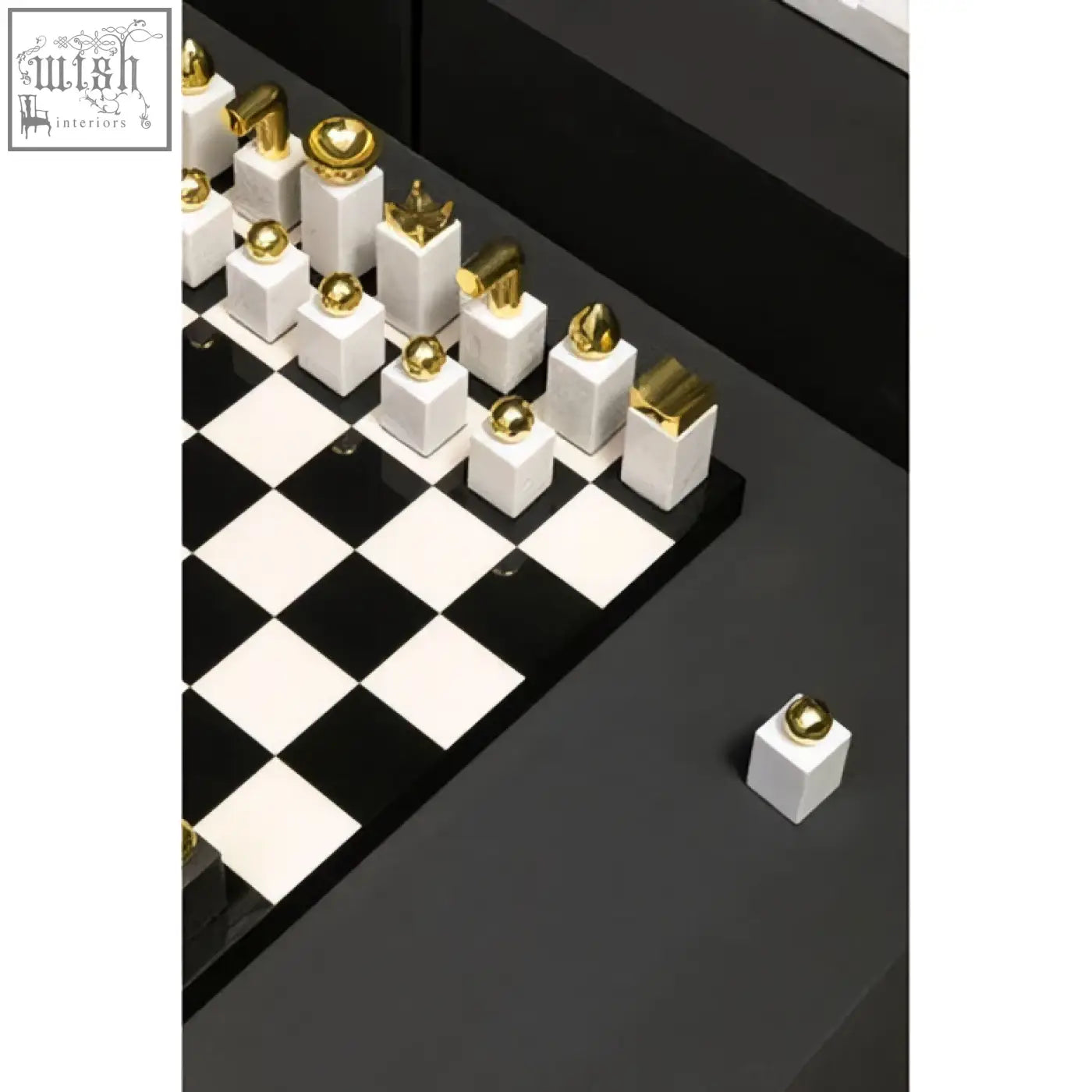 Flos marble and wood chess set with black and white pieces featuring gold accents on a glossy wood chess board