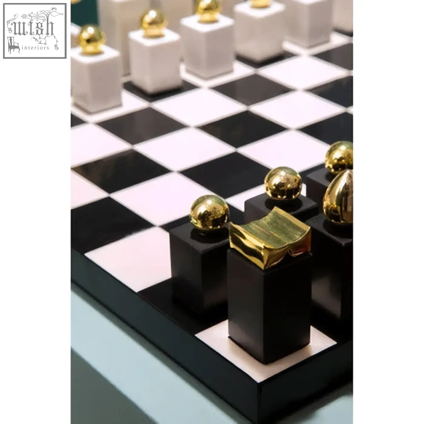 Flos marble and wood chess set with black and white wood chess pieces topped with gold accents