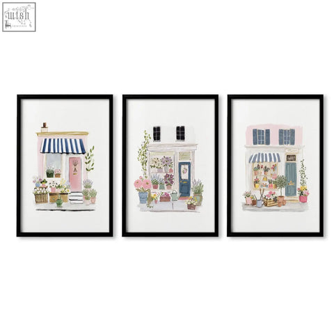 Set of 3 flower art prints featuring charming pastel flower shop facades with striped awnings and potted plants