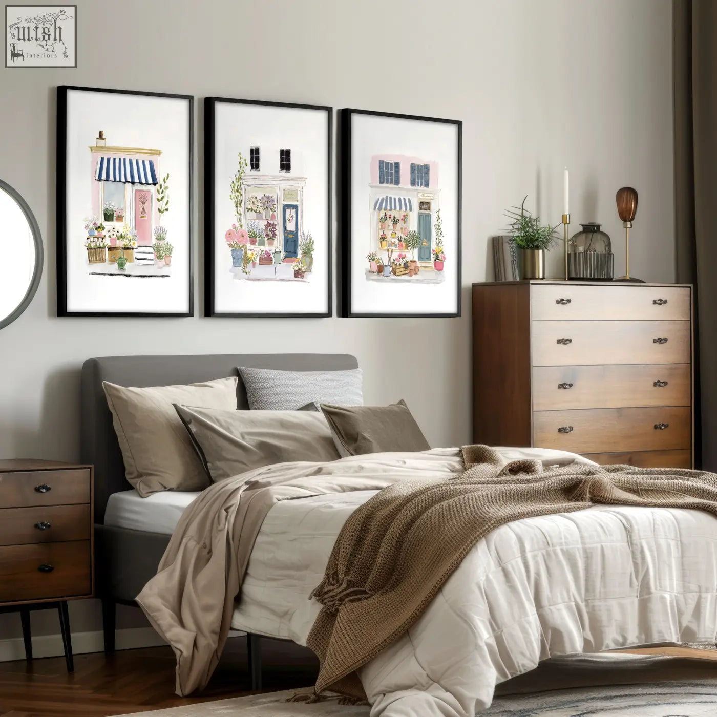 Three framed flower art prints of charming blue pink and white flower shop facades hang above the bed