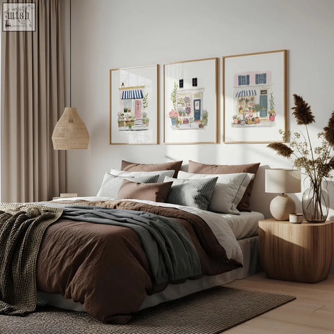 Cozy brown and gray layered bedding set with textured knit throw blanket beside flower shop art prints in blue pink and white