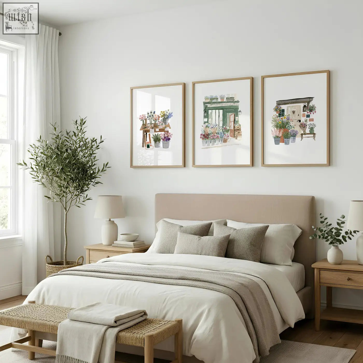 Three framed flower print botanical illustrations in light wood frames hang above the bed as flower shop wall art