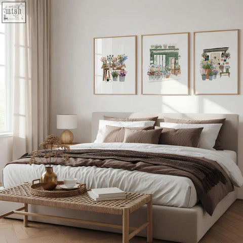 Beige upholstered bed with layered white and brown bedding and flower print flower shop wall art set of 3