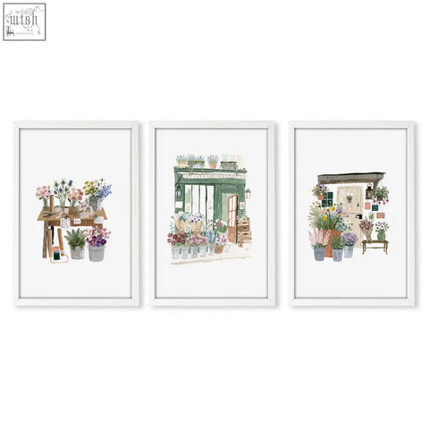 Set of three white-framed watercolor flower shop floral prints perfect as charming wall art for a cottage style space