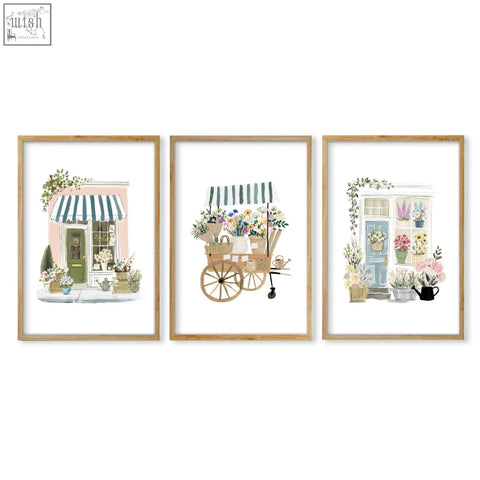 Set of three country cottage flower prints in light wood frames perfect for flower shop wall art decor