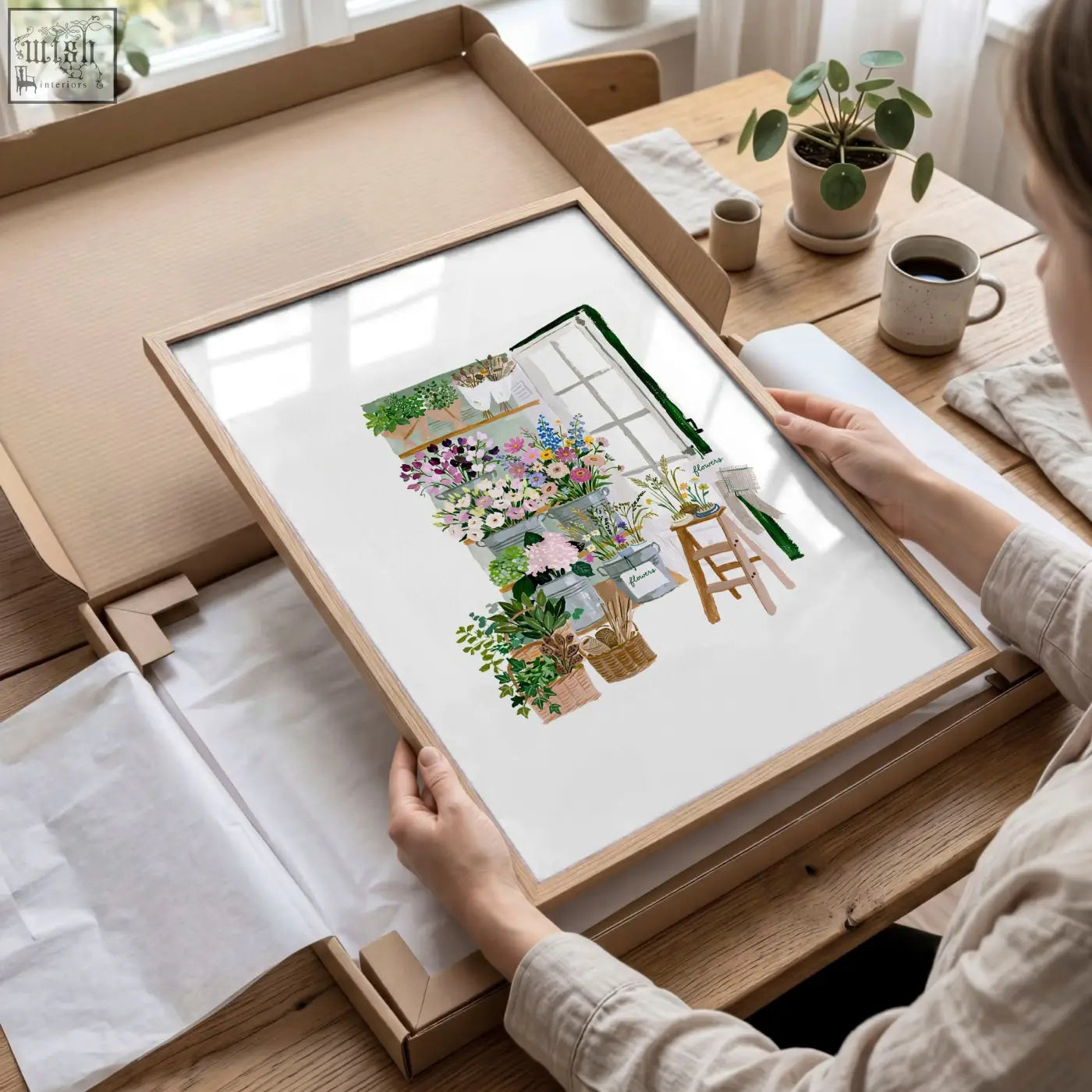 A light wood-framed flowers artwork print with colorful watercolor flowers and gardening tools for flower shop decor