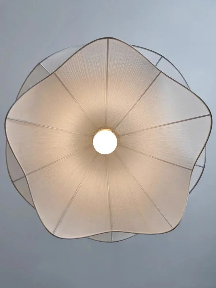 A delicate cream-colored flowers cloth chandelier lampshade with textured pattern and metallic trim for pendant lights
