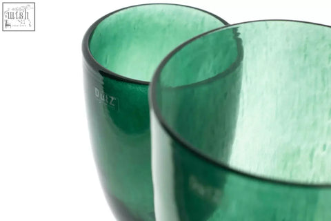 Two mouth blown emerald green glass tumblers from the dutz collection with textured finish and dutz brand etching