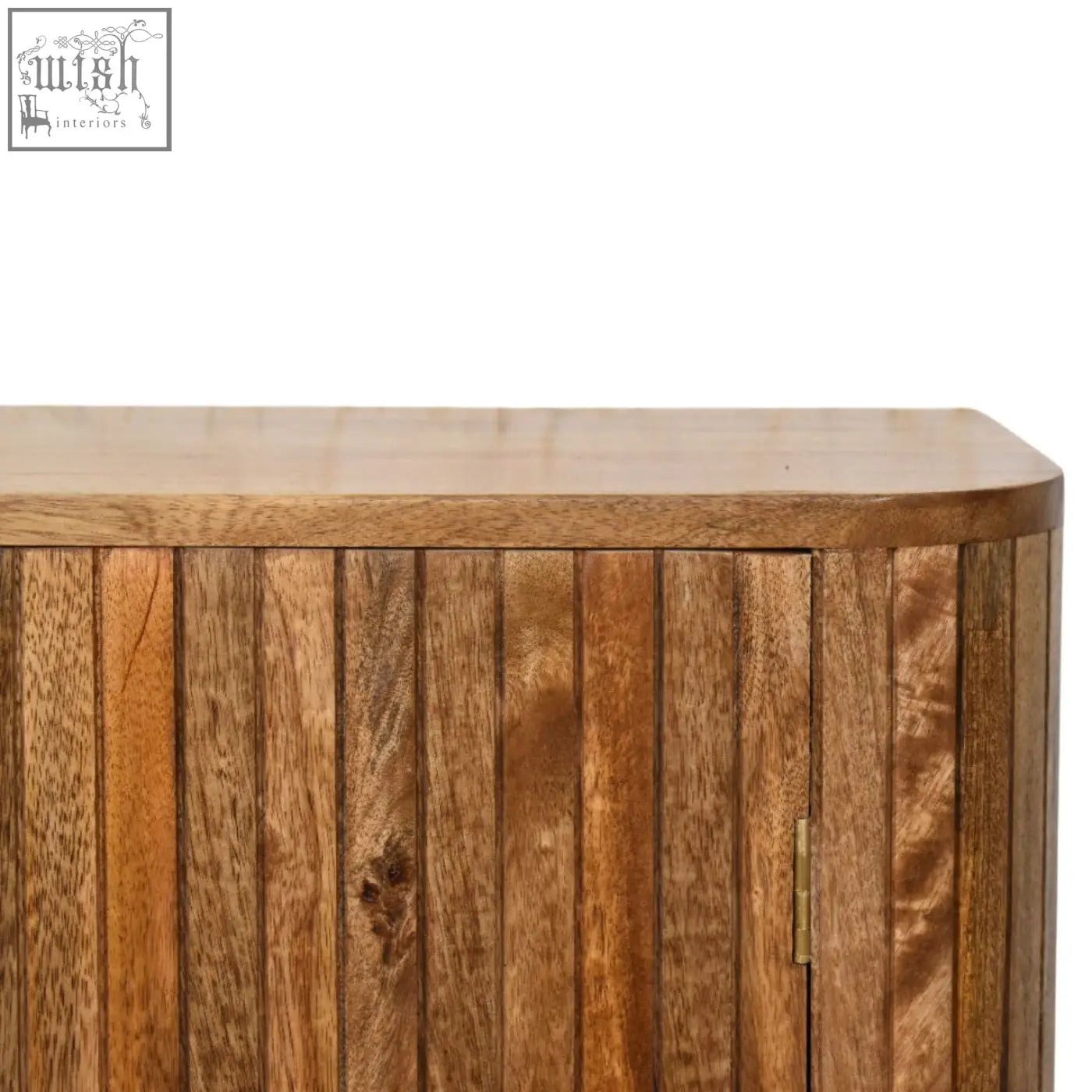 A warm-toned mango wood fluted curve chest of drawers with vertical slats and curved top edge showing grain patterns
