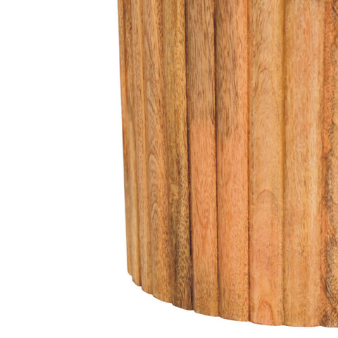 A fluted marble side table with vertical slats in warm natural mango wood perfect as an accent piece