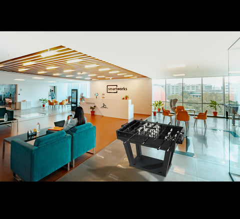 Black foosball table with metallic player figures and sleek modern design perfect for game rooms and entertainment