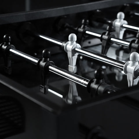Shiny chrome-plated foosball player figures mounted on black rods for a sleek foosball table setup