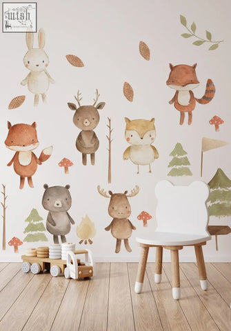 White bear-shaped chair with wooden legs and white foot caps in a forest animals nursery wall decal setting