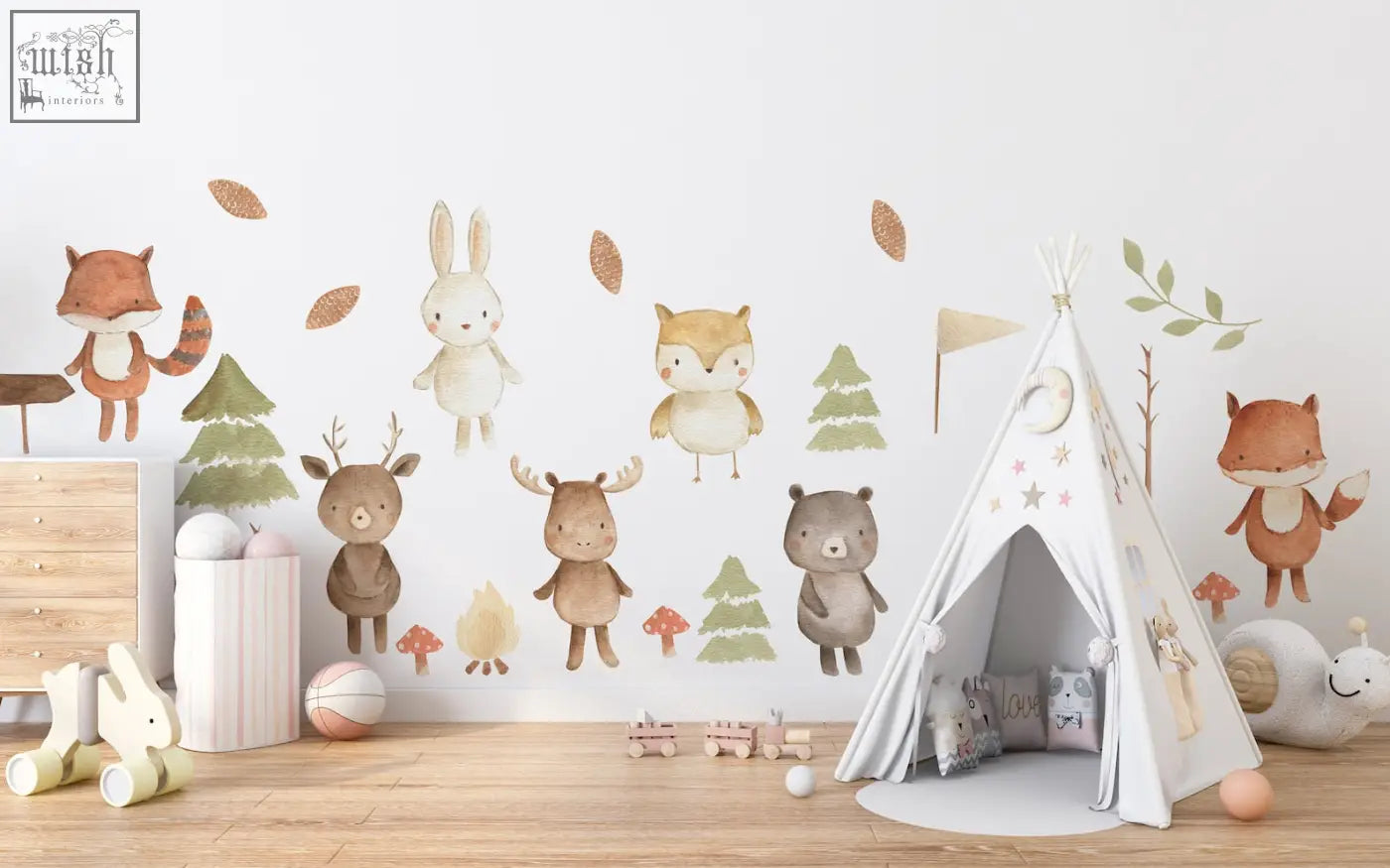 White teepee tent with star and moon decals for a forest animals nursery featuring peel and stick wall decals