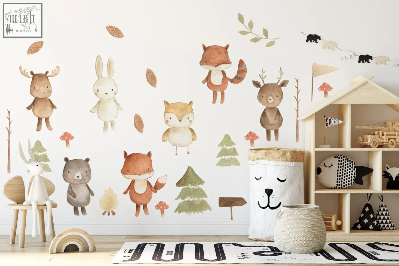 Wooden toy house with open shelves and small flag on top next to forest animals nursery wall decal stickers
