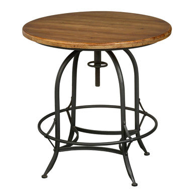 Foundry round top table with a dark brown wooden tabletop, black wrought iron legs, rounded edges, and circular footrest