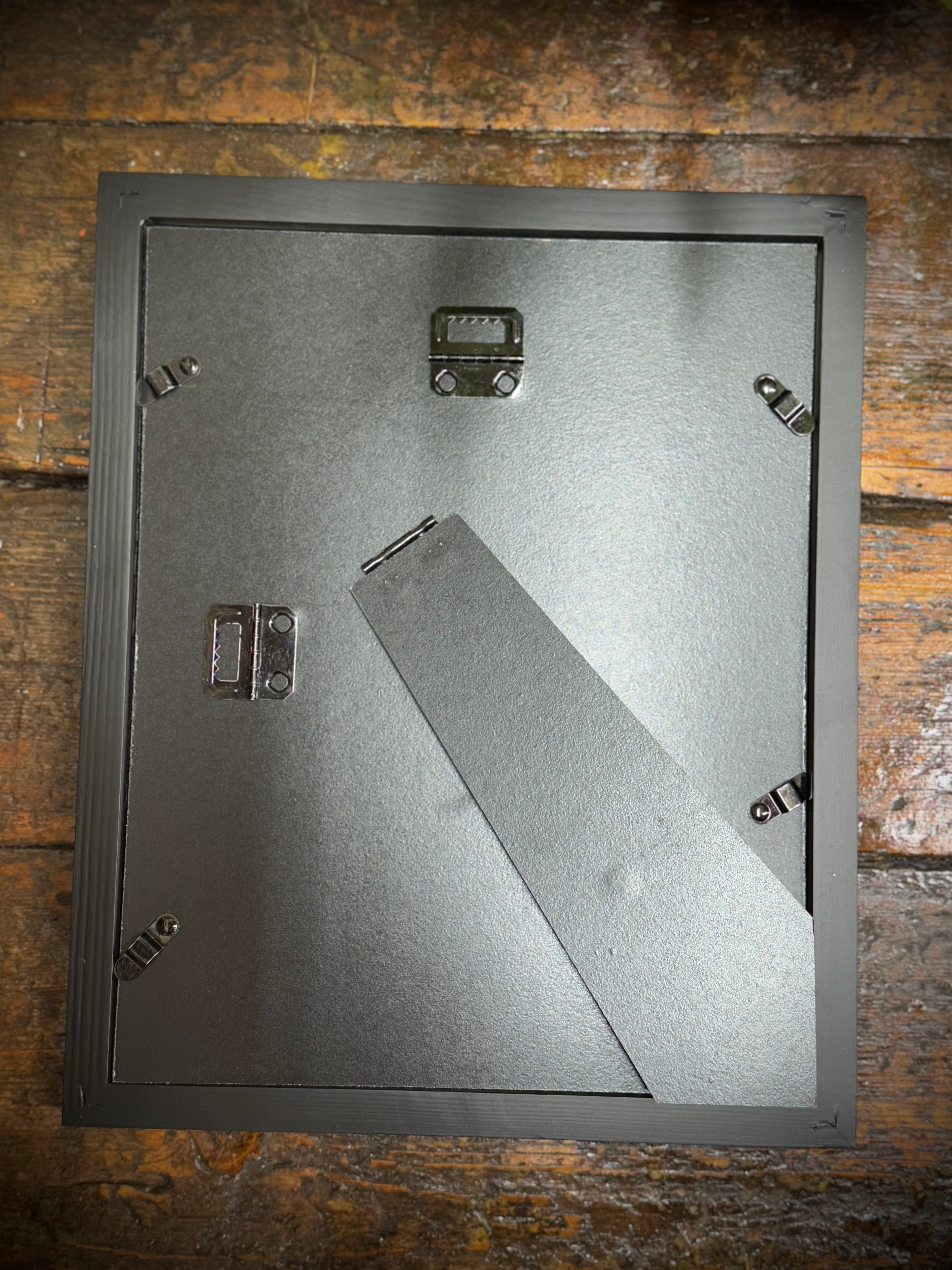 Black matte picture frame with built-in stand and corner brackets for 1920s medical book plate wall art
