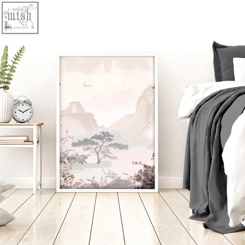 A framed minimalist landscape print with soft pink and gray mountains and blossoms in a white frame for chinoiserie wall art