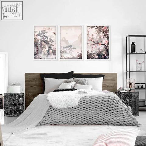 Three framed artworks featuring delicate pink blossoms and misty mountains perfect chinoiserie wall art above bed