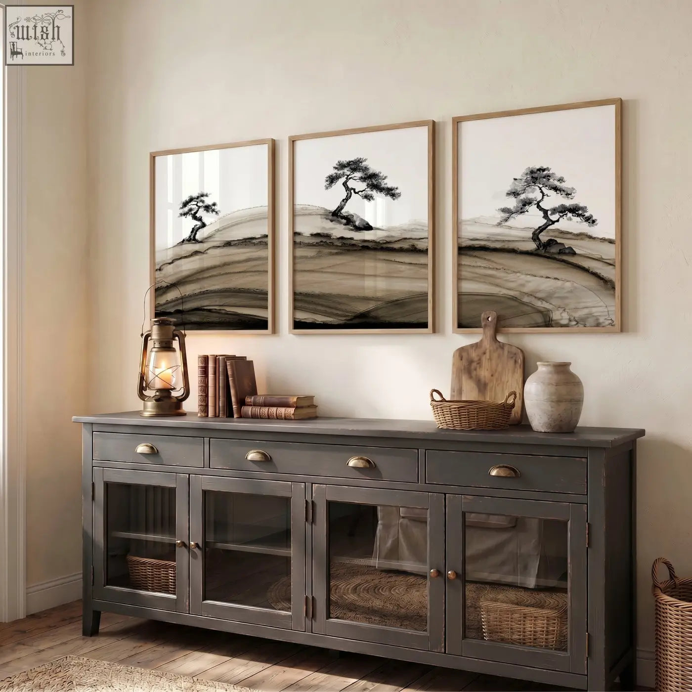 Dark gray wooden sideboard with glass cabinets and brass handles below framed asian wall art of japanese ink bonsai trees