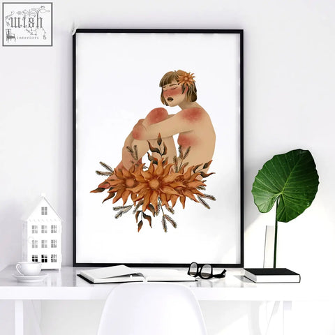 A framed watercolor wall art print of a woman with orange flowers perfect for bathroom wall art prints