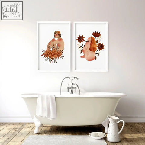 Two framed pictures featuring nude ladies with autumnal florals in white frames for bathroom wall art prints