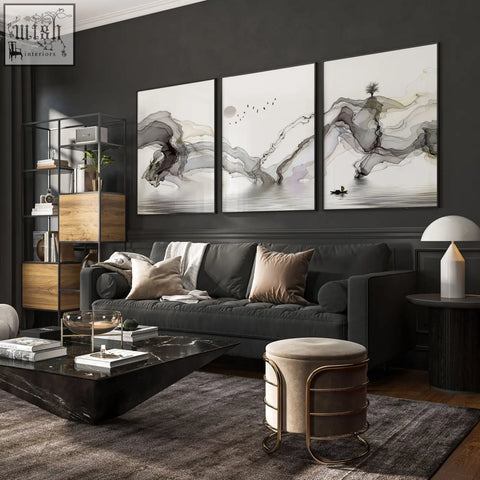 Dark gray upholstered sofa with plush cushions paired with framed pictures wall art prints for living room decor