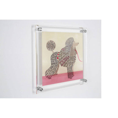 A sleek framed poodle wall art with a transparent acrylic frame and silver corners featuring black and white design