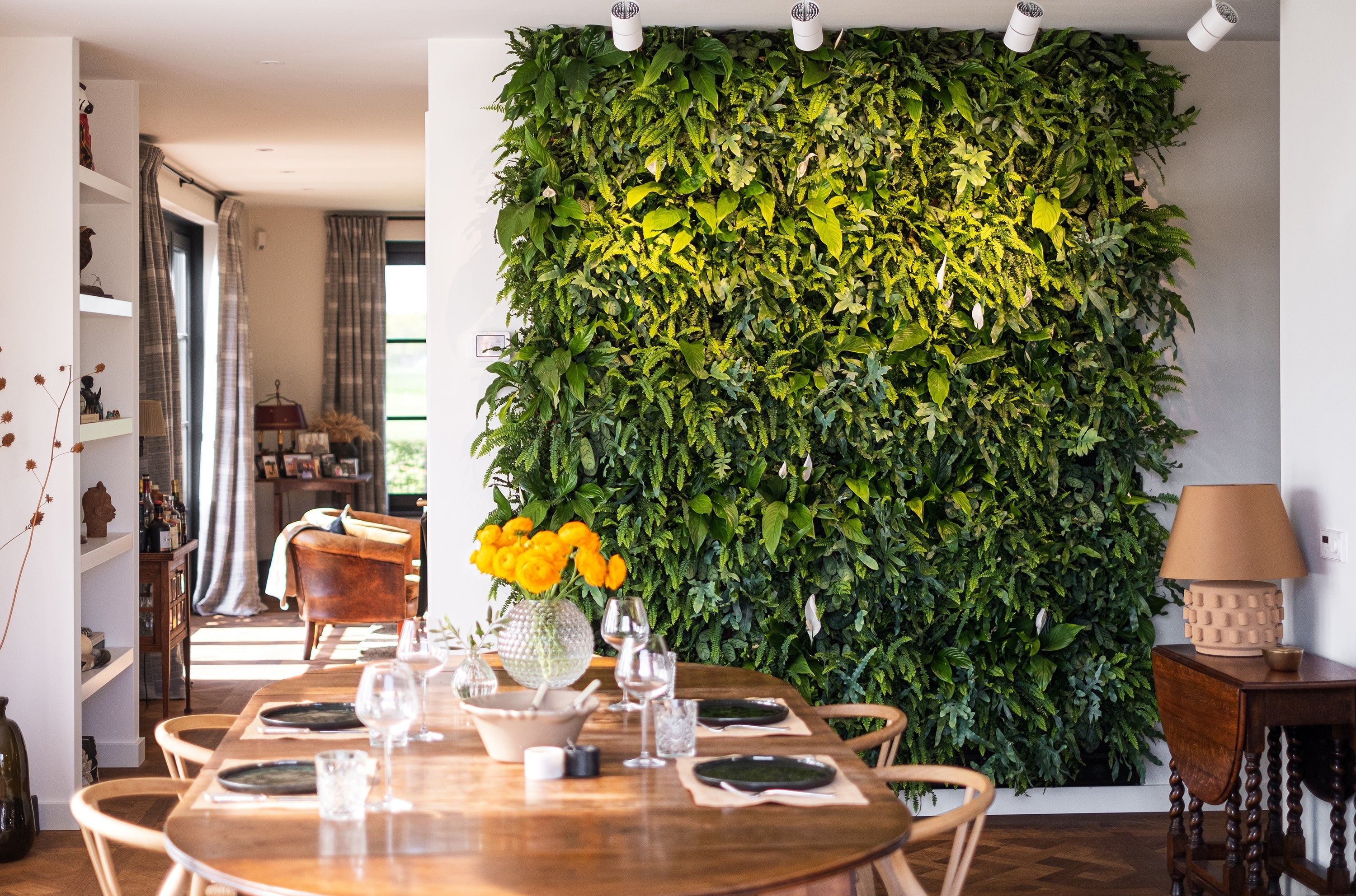 Lush green living wall with dense foliage in a frameless living wall system using a plant cassette table