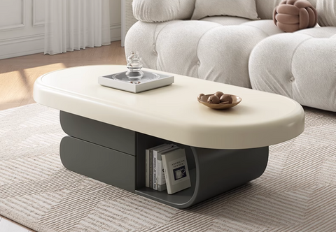 Cream-colored oval freda coffee table with sleek modern design and gray lower storage compartments in milky white