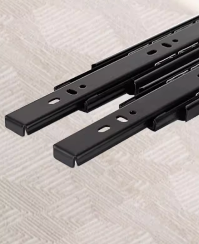 Black metal drawer slides with matte finish and smooth motion on milky white freda coffee table for easy storage access