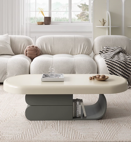 Cream-colored oval freda coffee table with a sleek modern design and gray curved base for stylish living rooms