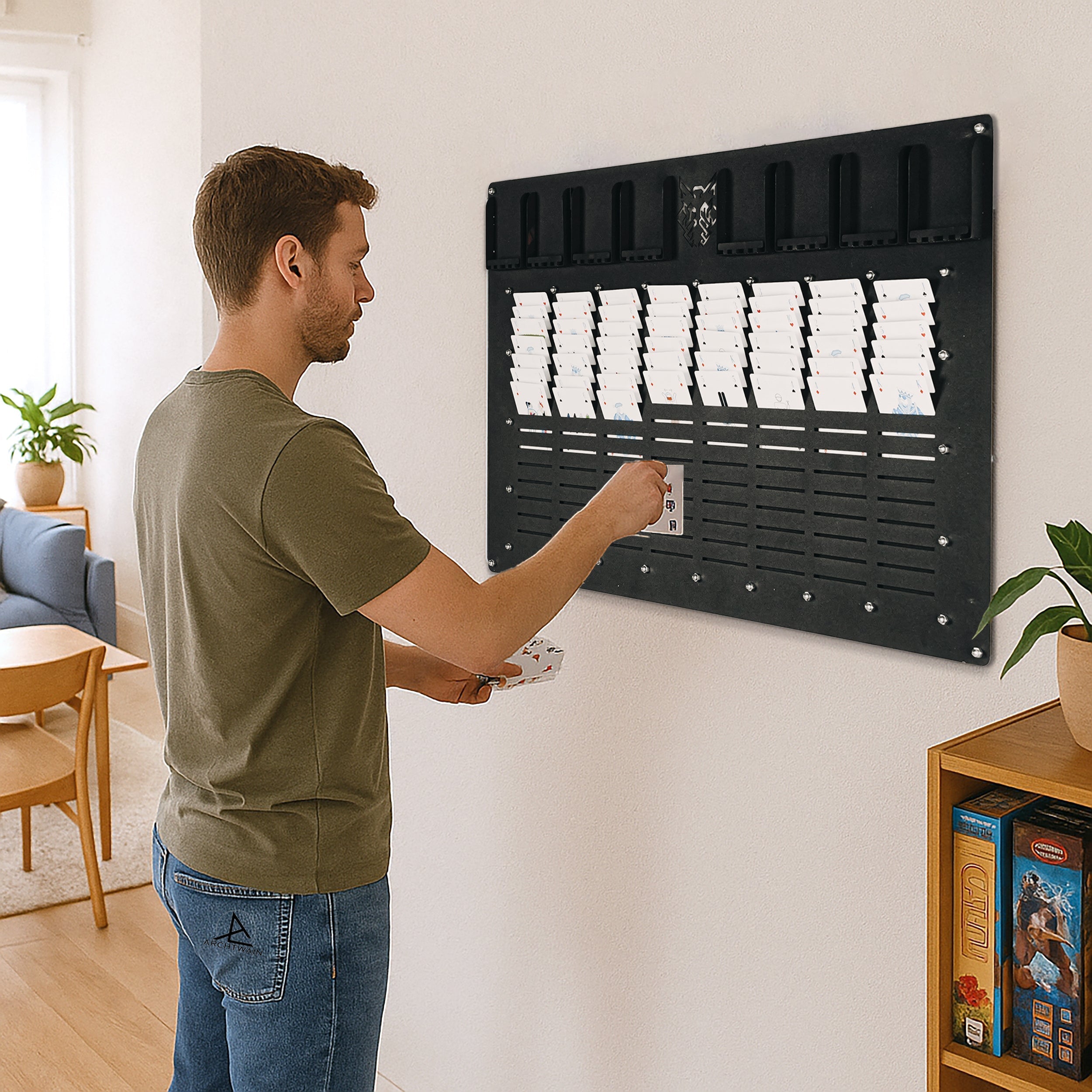 Black wall-mounted key card holder with multiple slots and decorative emblem for freecell wall game access cards