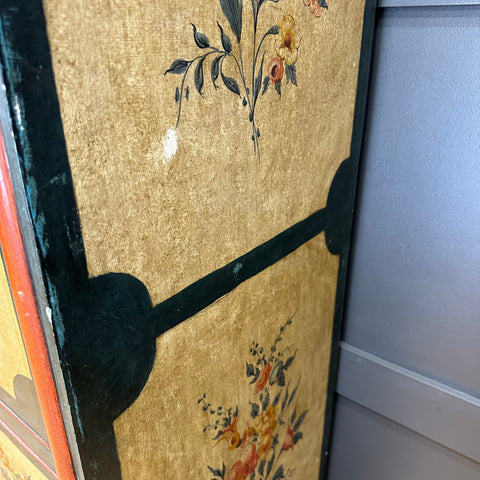 Golden-framed secretaire d’abattant with hand-painted floral motifs on textured gold background vintage cupboard