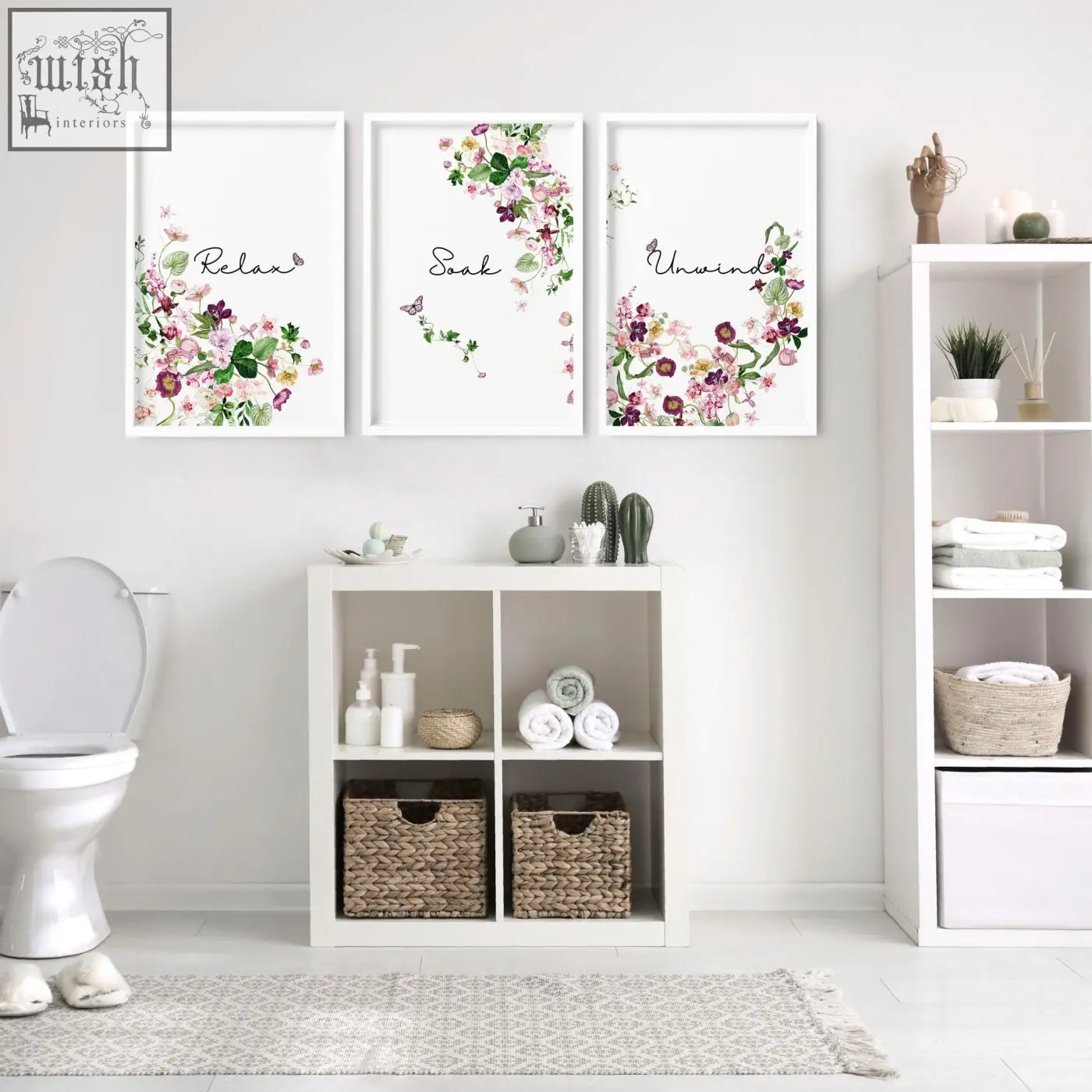 Three framed french style country wall art prints with watercolor floral blossoms in soft pinks purple and green above white shelf