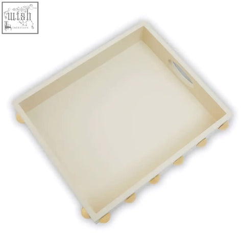 Cream rectangular gold studded tray with rounded corners and small spherical feet for stylish serving or decor