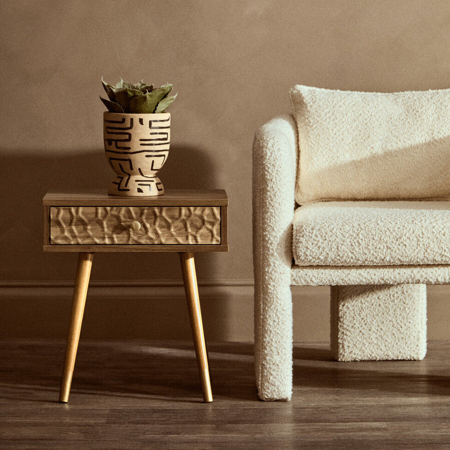 Beige ceramic planter with black etching holding green succulent on frida wood veneer bedside table with 1 drawer