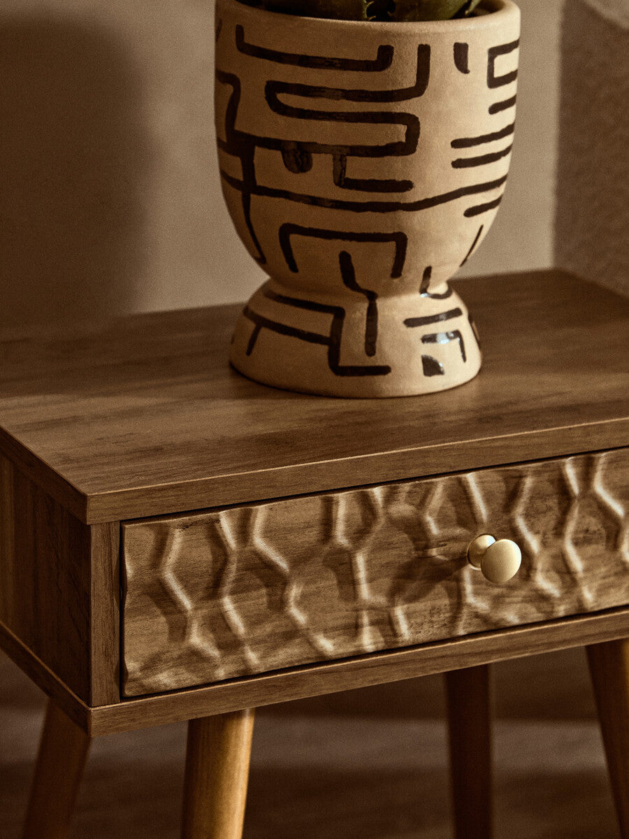 Beige ceramic planter with black maze patterns on a frida wood veneer bedside table with 1 drawer