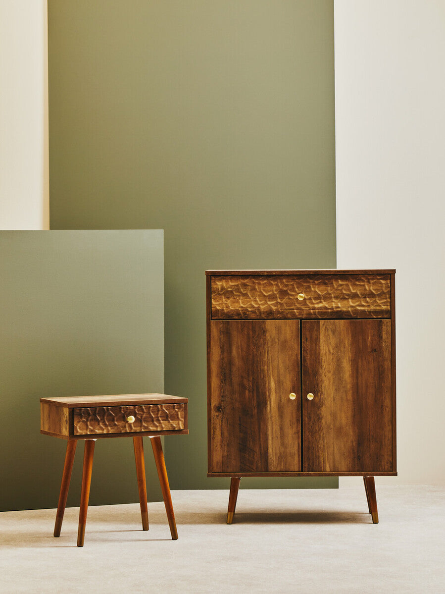 Frida wood veneer bedside table with one drawer featuring honey-toned wood grain and brass round knobs in mid-century style