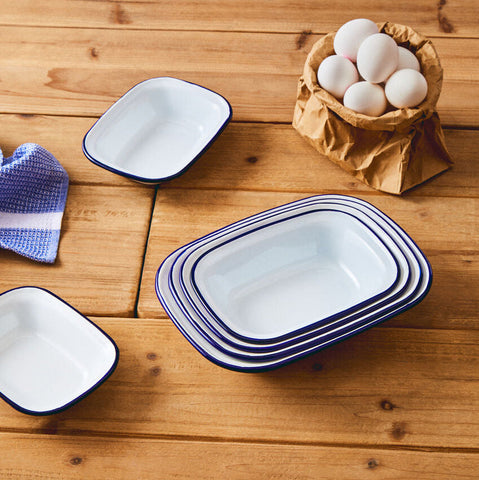 Stacked white enamel rectangular pie dishes with navy blue rims perfect for baking rectangular pies